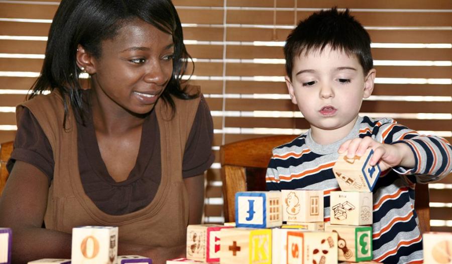 Teacher and student playing with blocks