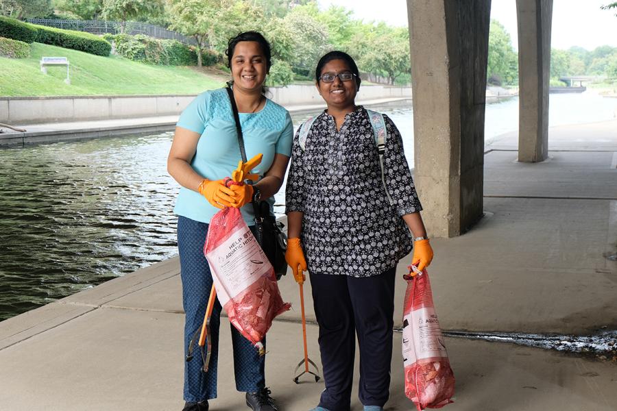 Two women collecting trash at a plogging event