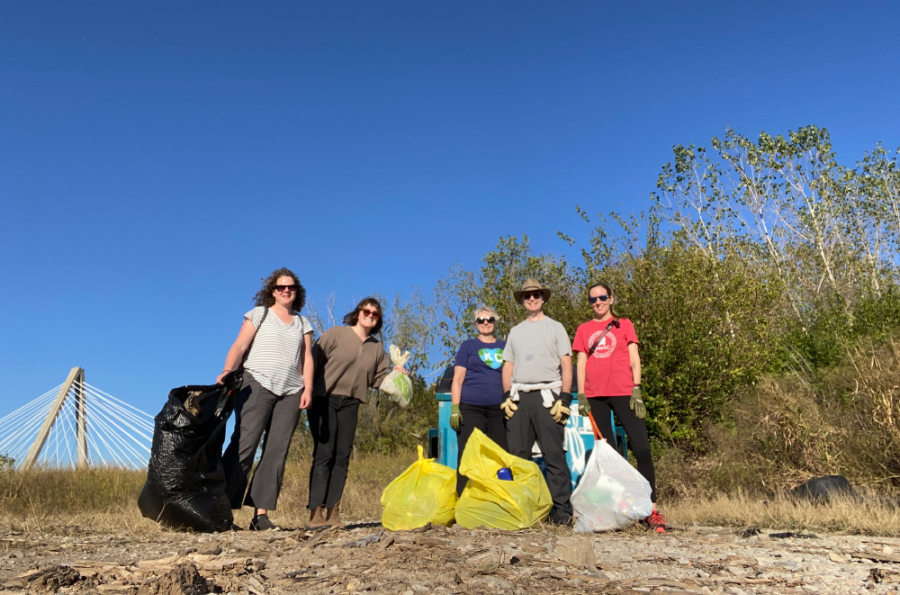 Volunteers pose with bags of trash along Riverfront Heritage walking trail along Berkley Riverfront Park in KCMO