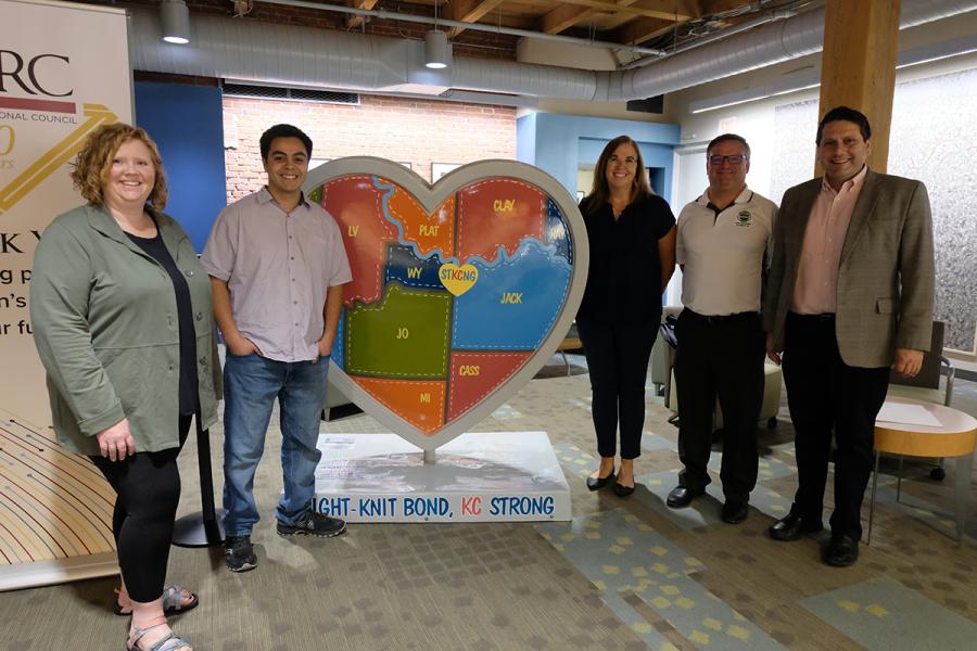 delegation from Clay County pose with MARC staff in front of heart sculpture in the MARC office lobby