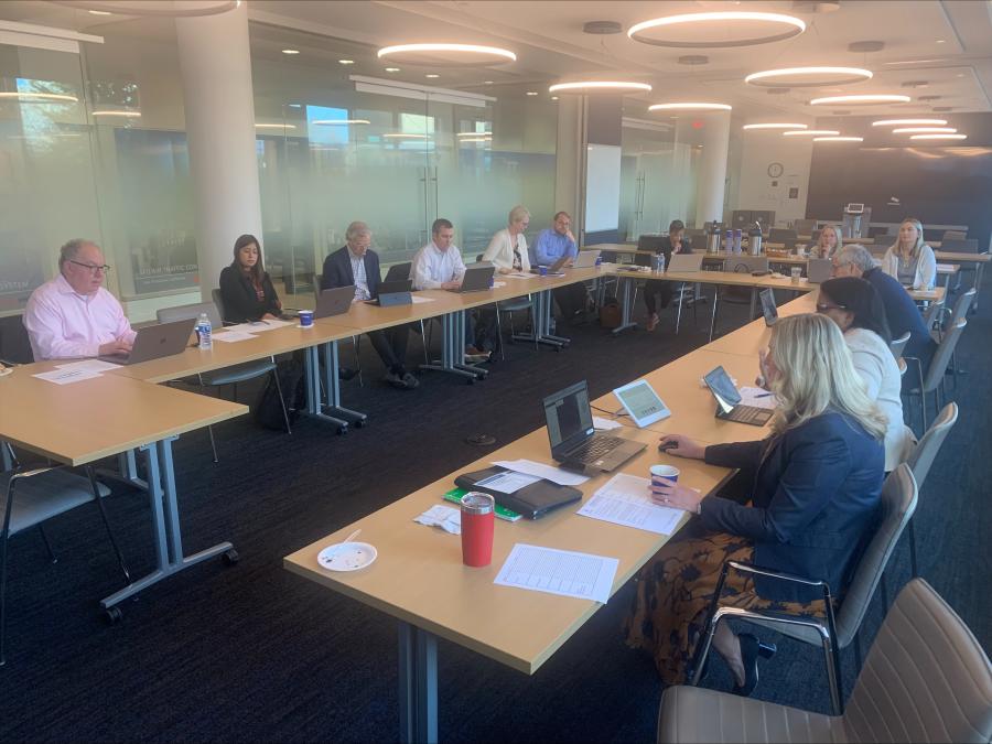 Members of KC Rising's Place Committee sit around a table using computers