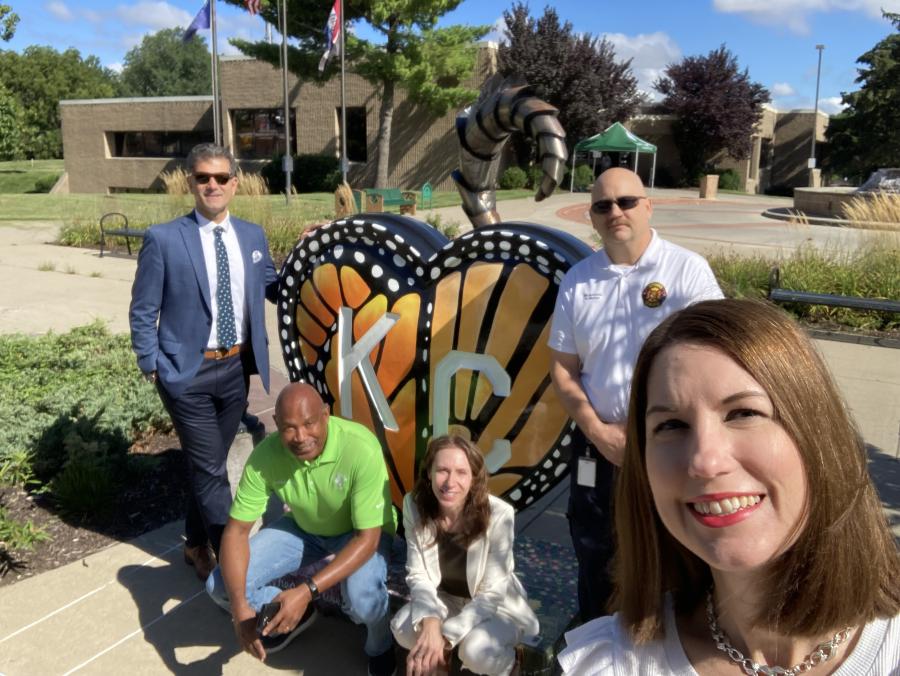 MARC staff member taking a Selfie with Grandview city staff in front of a Parade of Heart in Grandview. 