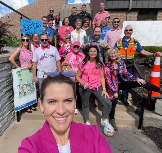 MARC staff taking a selfie with Prairie Village staff dressed in Barbie themed clothing for #CityHallSelfie Day. 