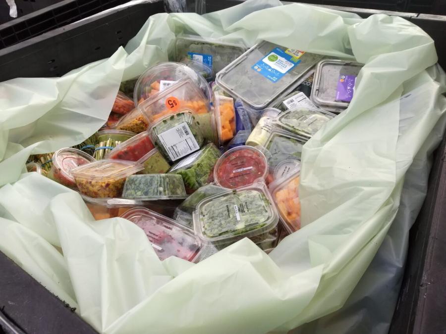 Expired packaged produce in a dumpster