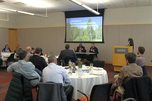 Photo of the attendees watching event speakers' presentation