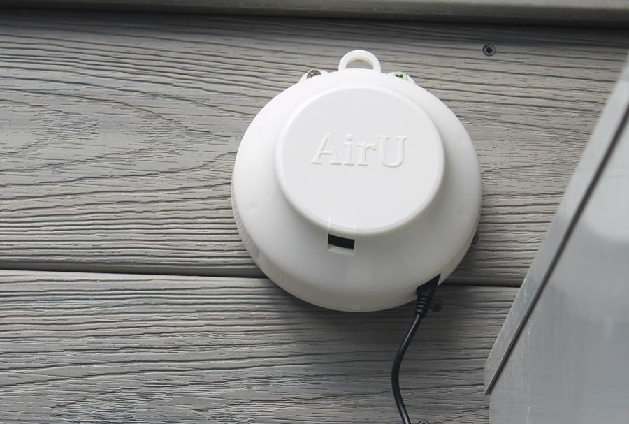Air quality sensor mounted to the exterior of a residential house.
