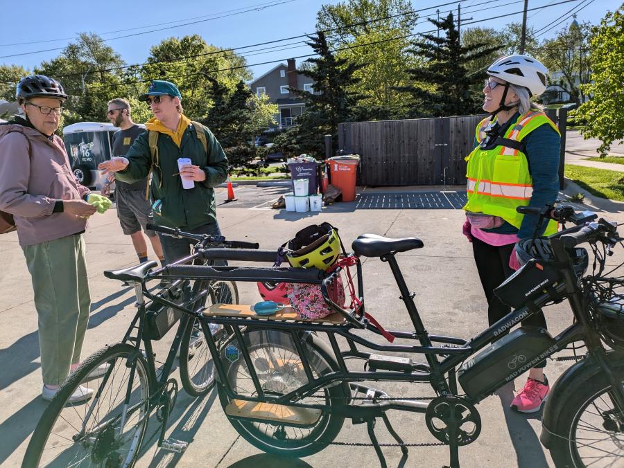 Event guests talking during the E-Bike Petting Zoo