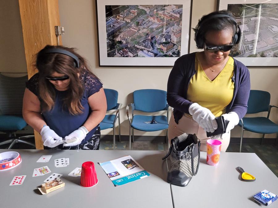 Dementia-friendly workshop dementia simulator trying household tasks with physical obstacles
