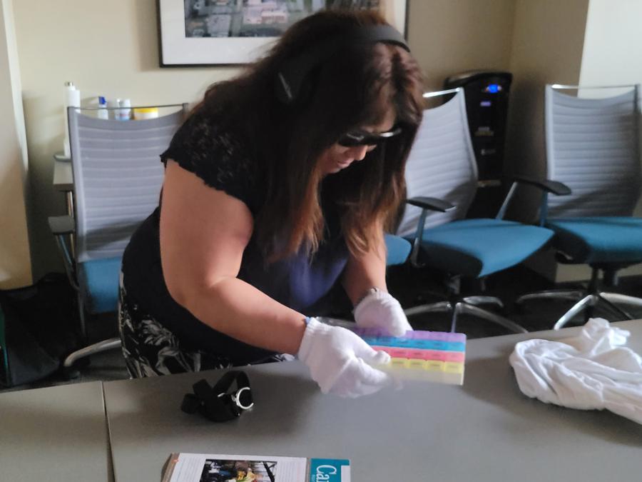 Dementia-friendly workshop dementia simulator trying household tasks with physical obstacles