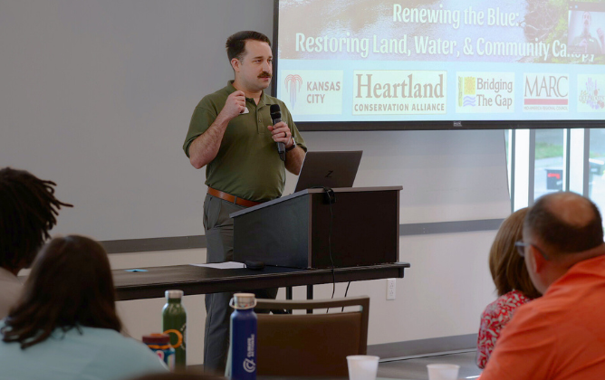 Speaker at a podium presenting to audience