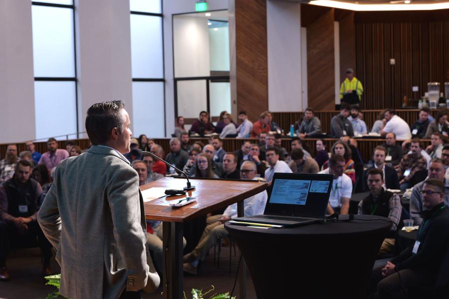 Keynote speaker Josh Roundy addresses audience at stormwater conference
