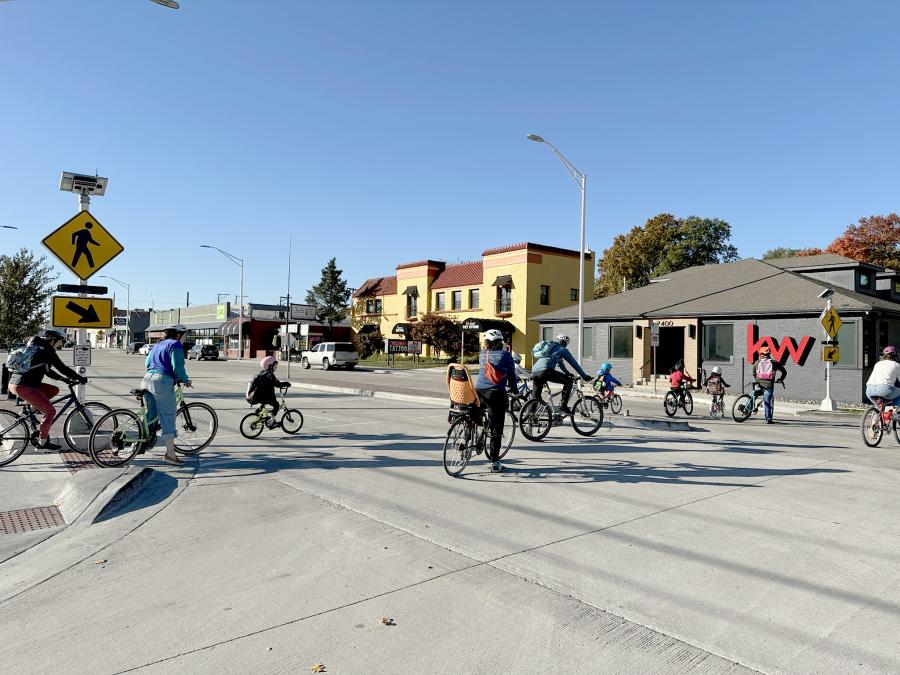 Group of bicycle riders going through crosswalk in Waldo 