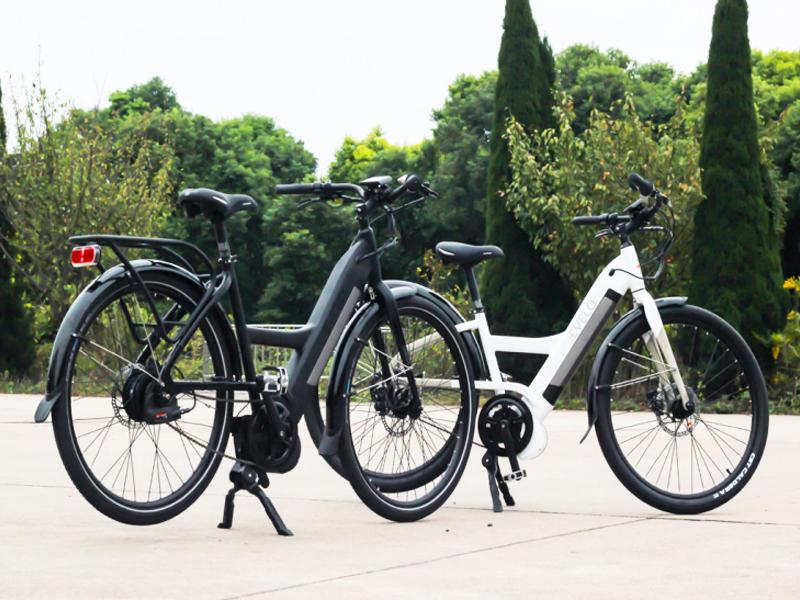 Two e-bikes on kickstands outside