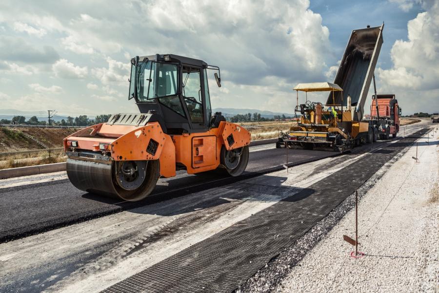 Road construction with asphalt being put on milled road